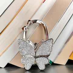 Novuxy® Elegant Foldable Butterfly Bag Hook for Women - Sparkling Metal Handbag Hanger, Portable Space-Saving Wall & Desktop Organizer